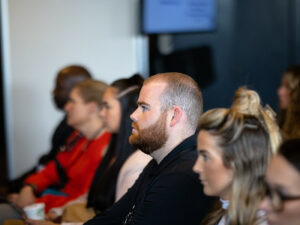 Attendees listening to presenter at sales meeting