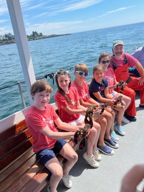 Kids with Lobster. Photo Credit: Visit Maine / Capshore Photography
