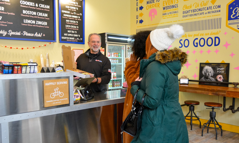 Socializing in donut store; Photo Credit: Lauren Peters at Visit Portland