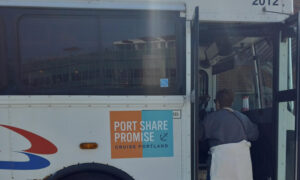 People boarding a white city loop shuttle bus; Photo Credit: Richard Leeman