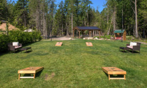 Outdoor lawn with cornhole games and seating; Photo Credit: Peter G. Morneau Photography