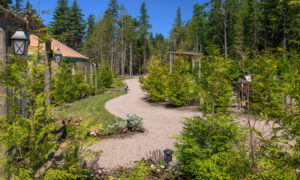 Outdoor yurts on gravel path near garden ; Photo Credit: Peter G. Morneau Photography
