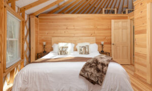 Acadia Wilderness Lodge yurt luxury king bedroom; Photo Credit: Peter G. Morneau Photography