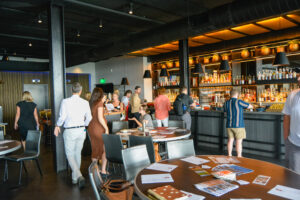 Group of people socializing at restaurant and bar; Photo Credit: Lauren Peters at Visit Portland
