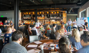 Media presentation to group of people at a bar; Photo Credit: Lauren Peters at Visit Portland