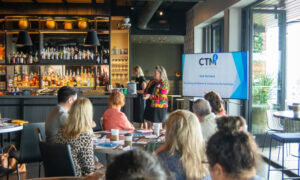Media presentation to group of people at a bar; Photo Credit: Lauren Peters at Visit Portland