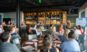 Media presentation to group of people at a bar; Photo Credit: Lauren Peters at Visit Portland