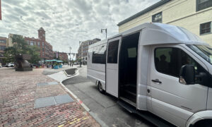 White city loop shuttle bus on cloudy day; Photo Credit: Angie Helton