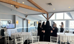 Women standing and socializing; Photo Credit: Lauren Peters at Visit Portland