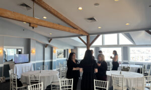 Women standing and socializing; Photo Credit: Lauren Peters at Visit Portland