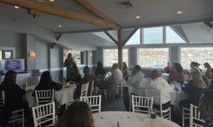 Speaker presentation with group of people; Photo Credit: Lauren Peters at Visit Portland