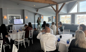Speaker presentation with group of people; Photo Credit: Lauren Peters at Visit Portland