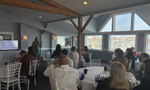 Speaker presentation with group of people; Photo Credit: Lauren Peters at Visit Portland