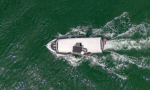 Aerial of white boat sailing in green ocean; Photo Credit: Peter G. Morneau Photography