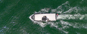 Boat cruising through green ocean; Photo Credit: Peter G. Morneau Photography