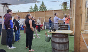 Group throwing axes at Axe Pit Garden; Photo Credit: The Axe Pit