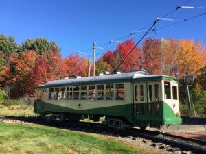 Trolley surrounded by fall leaves; Photo Credit: Seashore Trolley Museum