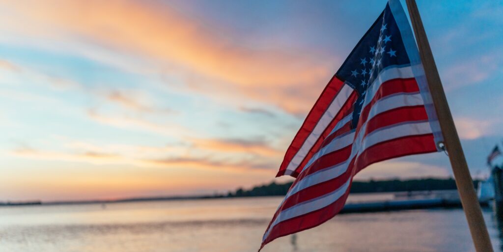 American flag over Casco Bay, Photo Credits: Digital Edge