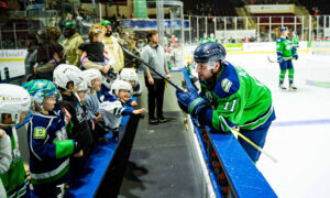 Hockey player talking with little kids; Photo Credit: Maine Mariners Photography Team