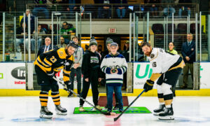Posing for the puck drop before a hockey game; Photo Credit: Maine Mariners Photography Team