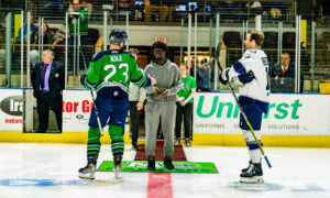 Posing for the puck drop before a hockey game; Photo Credit: Maine Mariners Photography Team