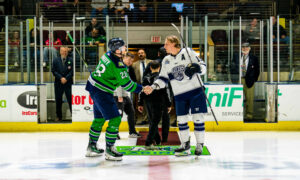 Posing for the puck drop before a hockey game; Photo Credit: Maine Mariners Photography Team