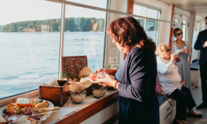 Woman eating from buffet on boat ride; Photo Credit: Kivalo