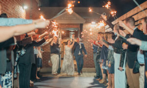 Couple celebrating wedding exit with sparklers: Photo Credit: Kivalo