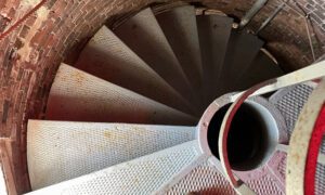 Inside a lighthouse steps, looking down; Photo Credit: Maine Maritime Museum