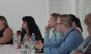 People focusing during presentation; Photo Credit: Digital Edge