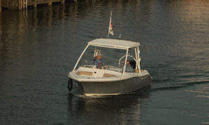 Boat cruising into working waterfront; Photo Credit: Digital Edge