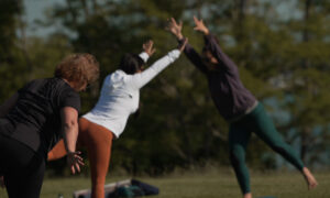 Doing yoga in a park; Photo Credit: Digital Edge