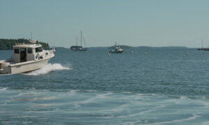 Boat cruising through Casco Bay; Photo Credit: Digital Edge