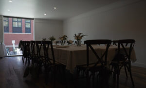 Long white table set for eating; Photo Credit: Digital Edge