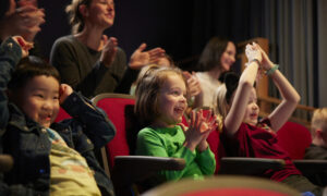 Kids watching a children's play; Photo Credit: Zack Bowen
