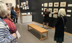 Tour guide explaining exhibit: Photo Credit: Maine Maritime Museum