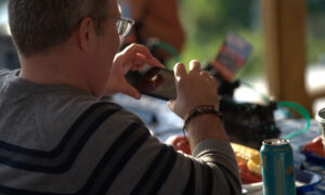Man taking picture of Maine lobster dinner; Photo Credit: Digital Edge