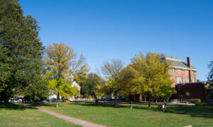 Green trees and red brick building in fall; Photo Credit: Lauren Witt at Visit Portland