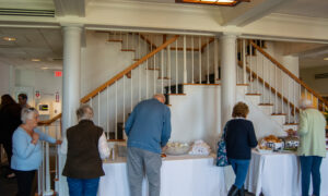 People getting food from a breakfast buffet; Photo Credit: Lauren Witt at Visit Portland