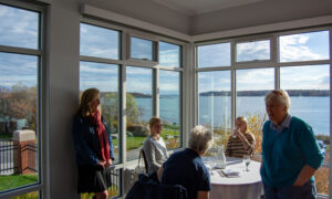 People enjoying McKernan Inn sun room with a view; Photo Credit: Lauren Witt at Visit Portland