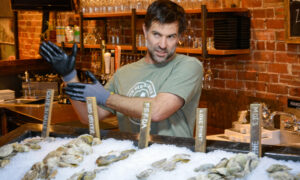 Man explaining oysters; Photo Credit: Lauren Witt at Visit Portland