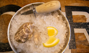 Oyster and shucker; Photo Credit: Lauren Witt at Visit Portland