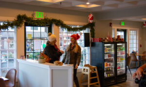 Women walking into decorated coffee shop; Photo Credit: Lauren Witt at Visit Portland
