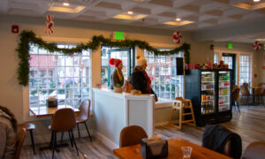 Women walking into decorated coffee shop; Photo Credit: Lauren Witt at Visit Portland
