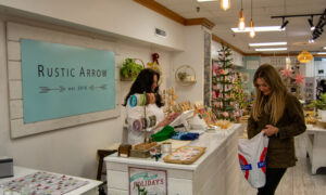 Woman checking out at store; Photo Credit: Lauren Witt at Visit Portland
