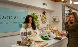 Woman checking out at store; Photo Credit: Lauren Witt at Visit Portland