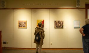 Woman admiring history exhibit; Photo Credit: Lauren Witt at Visit Portland