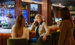 Women talking while at bar; Photo Credit: Lauren Witt at Visit Portland