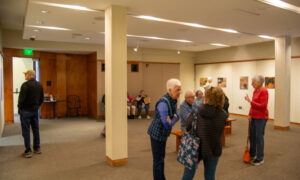 Group admiring art in gallery; Photo Credit: Lauren Witt at Visit Portland