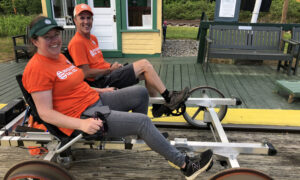 People biking on train tracks; Photo Credit: Seashore Trolley Museum Collection